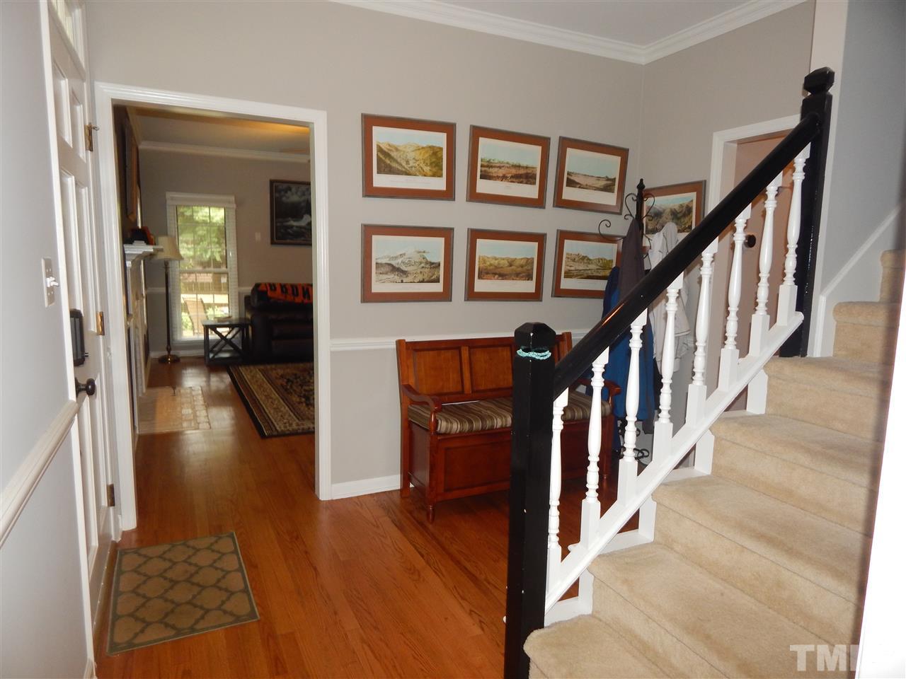 910 Albany Court Raleigh, NC 27615 - Photo 3 of 14 a view of a hallway with wooden floor and staircase