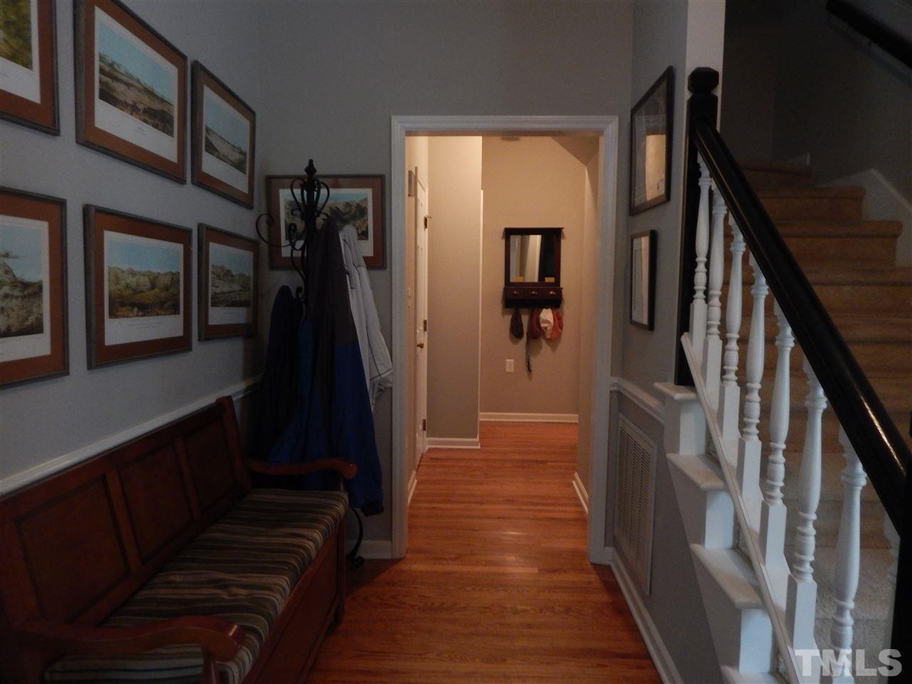 910 Albany Court Raleigh, NC 27615 - Photo 4 of 14 a hallway with wooden floor and stairs