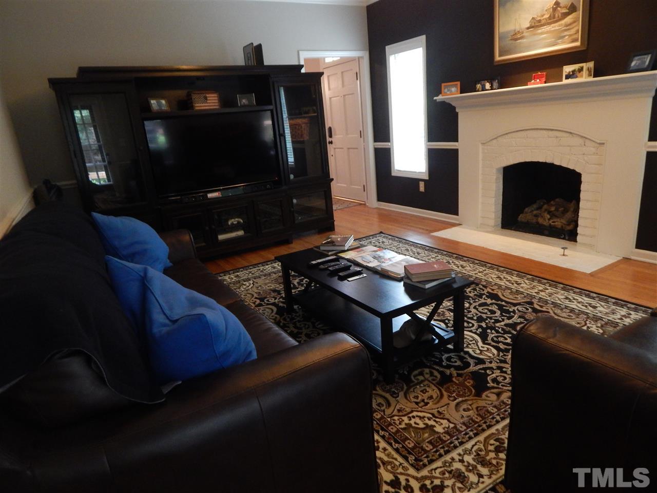 910 Albany Court Raleigh, NC 27615 - Photo 5 of 14 a living room with furniture and a fireplace