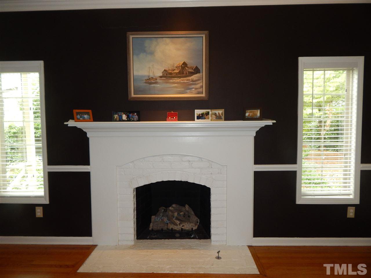 910 Albany Court Raleigh, NC 27615 - Photo 6 of 14 a living room with furniture and a fireplace