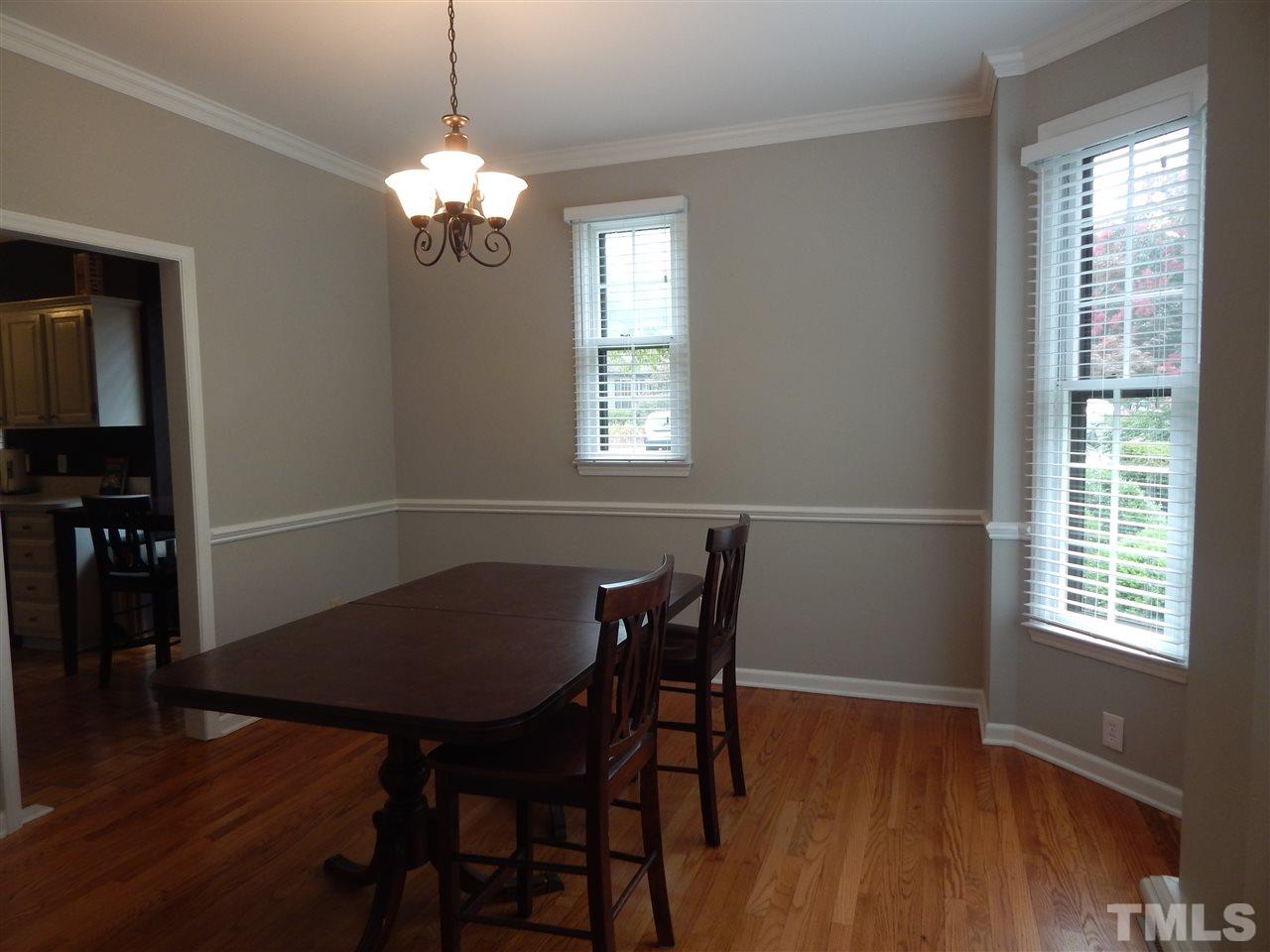 910 Albany Court Raleigh, NC 27615 - Photo 8 of 14 a view of a dining room with furniture and wooden floor