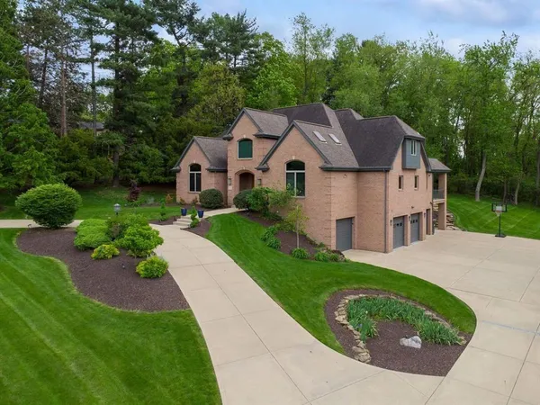 a aerial view of a house with a yard and potted plants