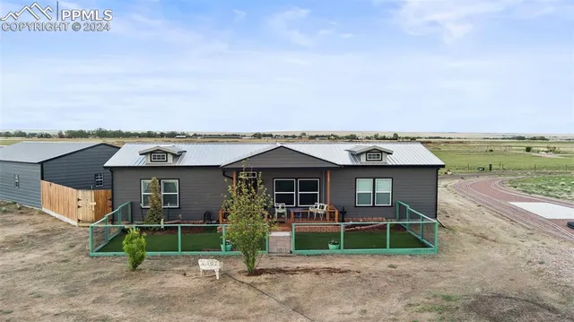 an aerial view of a house with a yard