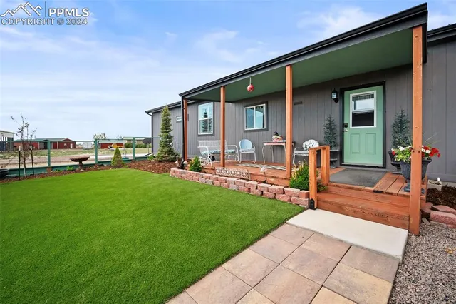a front view of house with yard and outdoor seating
