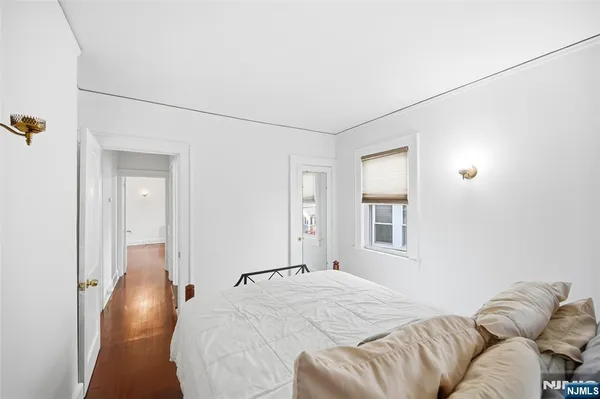 a bedroom with a bed and glass windows
