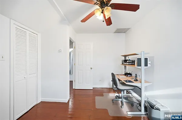 a view of a workspace with furniture and a window