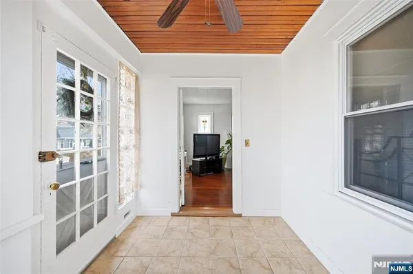a view of a hallway and wooden floor and a window