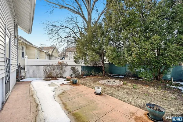 a view of backyard with a patio