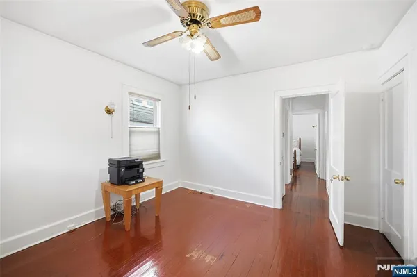 wooden floor & ceiling fan in a room