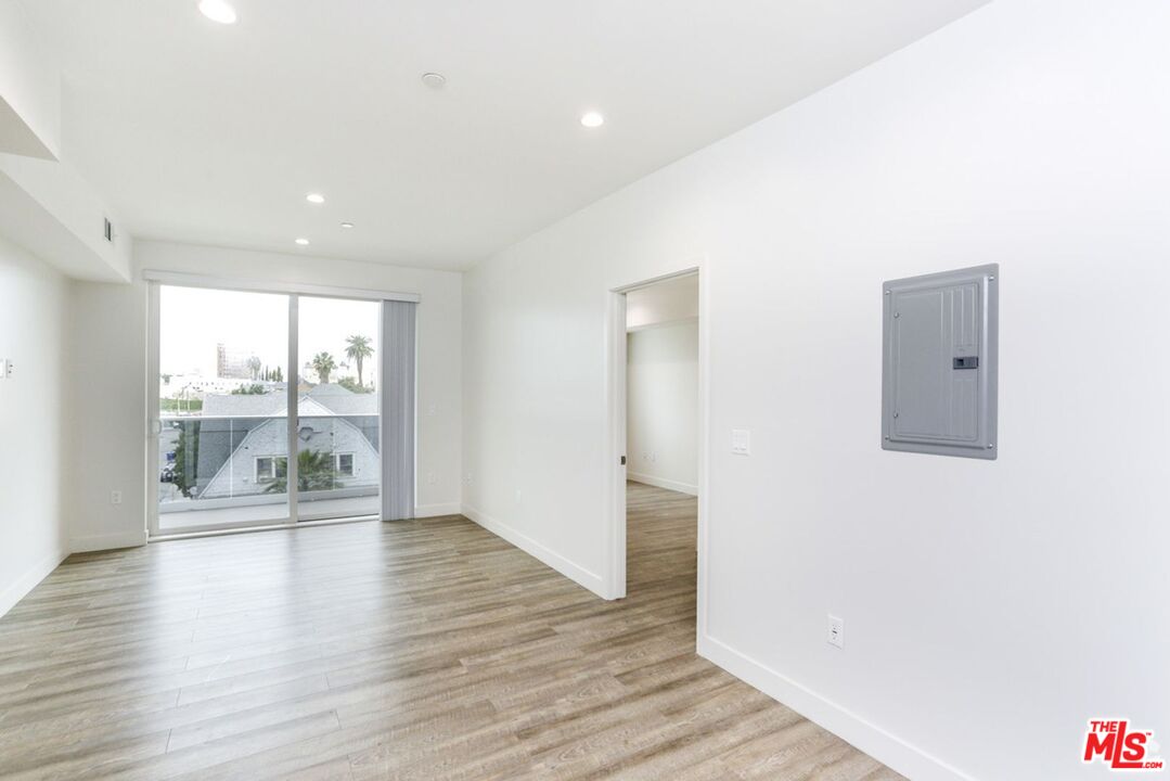 744 Hartford Avenue, Unit 301 Los Angeles, CA 90017 - Photo 3 of 15 a view of an empty room with wooden floor and a window