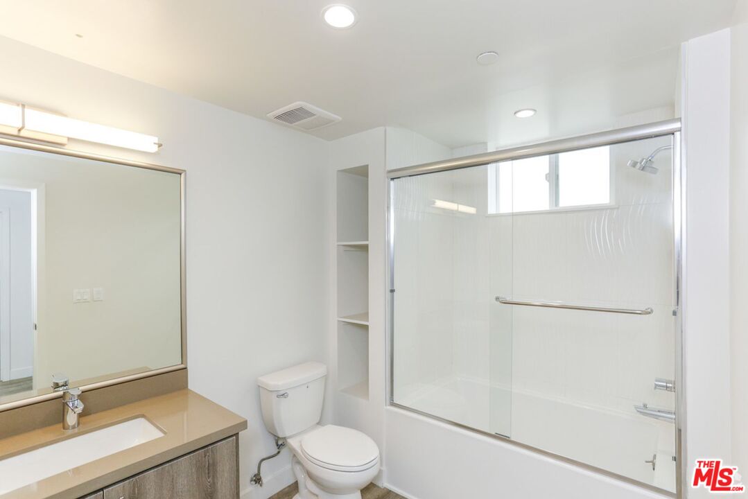 744 Hartford Avenue, Unit 301 Los Angeles, CA 90017 - Photo 8 of 15 a bathroom with a sink a toilet and shower