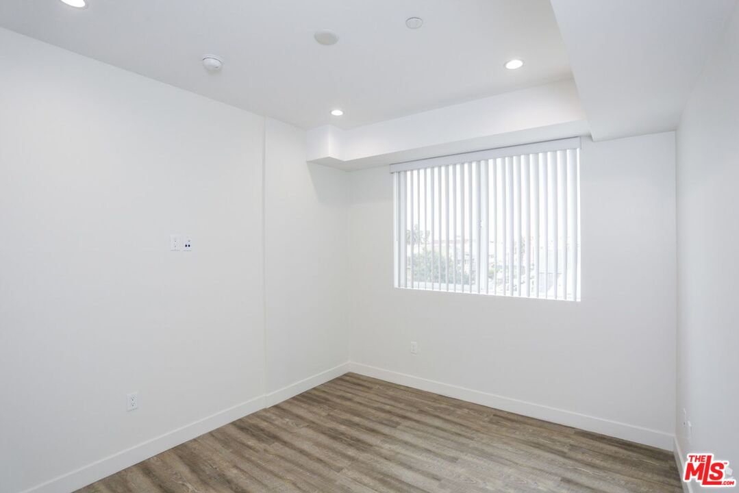 744 Hartford Avenue, Unit 301 Los Angeles, CA 90017 - Photo 10 of 15 an empty room with wooden floor and windows