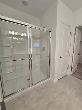 a bathroom with a glass shower door