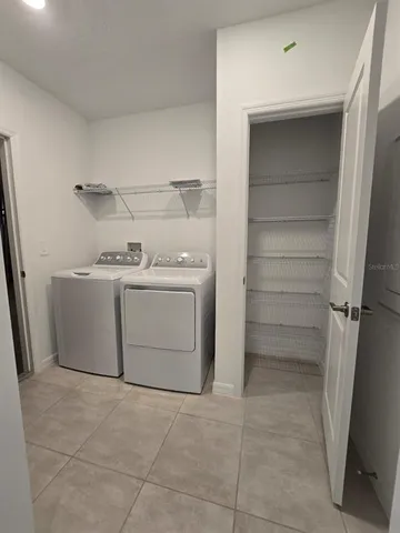 a utility room with cabinets washer and dryer