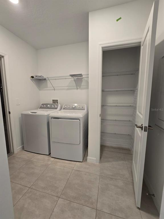 1373 Addison Blf Lane Kissimmee, FL 34744 - Photo 13 of 15 a utility room with cabinets washer and dryer