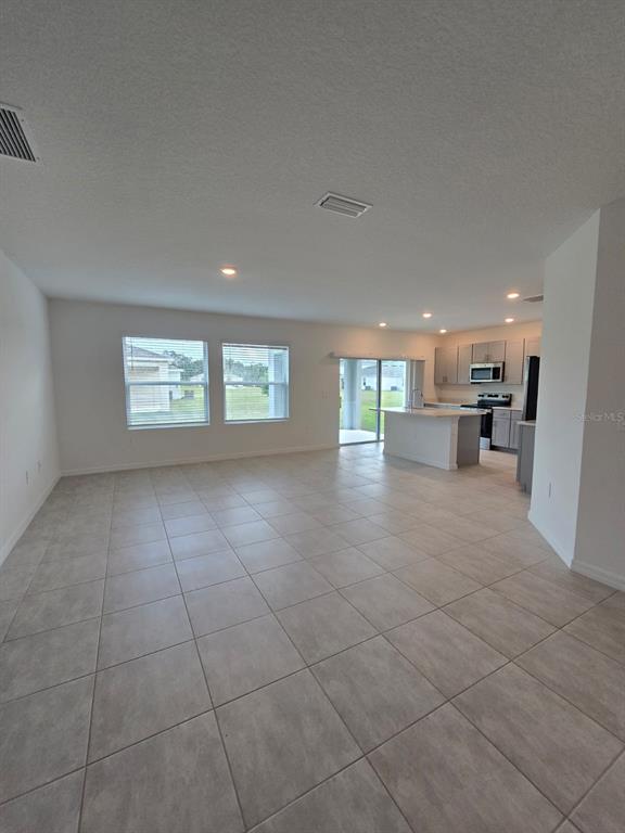 1373 Addison Blf Lane Kissimmee, FL 34744 - Photo 6 of 15 a view of an empty room with a window