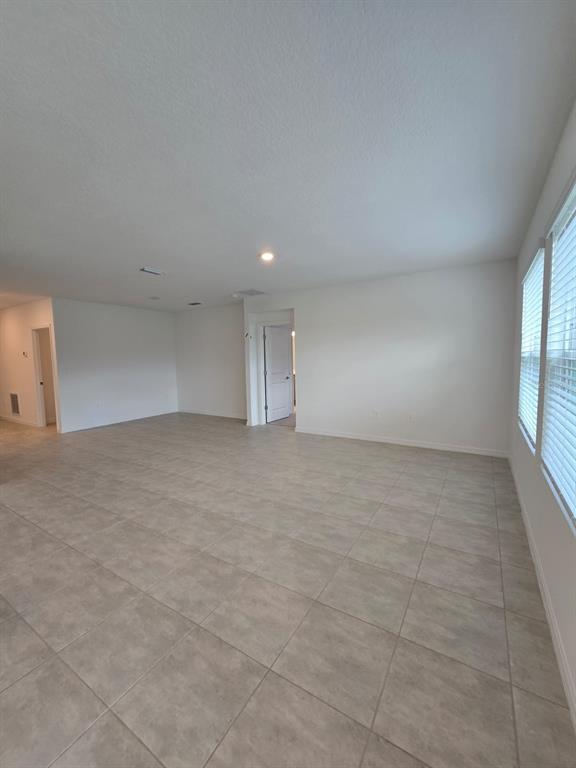 1373 Addison Blf Lane Kissimmee, FL 34744 - Photo 8 of 15 an empty room with windows