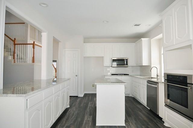 521 Mustang Ridge Drive Murphy, TX 75094 - Photo 11 of 31 a kitchen with cabinets and stainless steel appliances