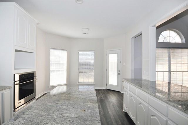 521 Mustang Ridge Drive Murphy, TX 75094 - Photo 12 of 31 an empty room with wooden floor and windows