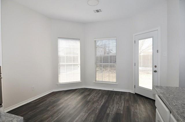 521 Mustang Ridge Drive Murphy, TX 75094 - Photo 13 of 31 an empty room with wooden floor and windows