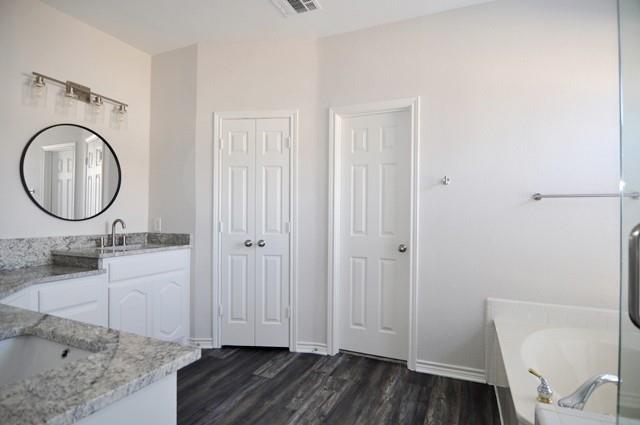 521 Mustang Ridge Drive Murphy, TX 75094 - Photo 17 of 31 a bathroom with a sink and a mirror