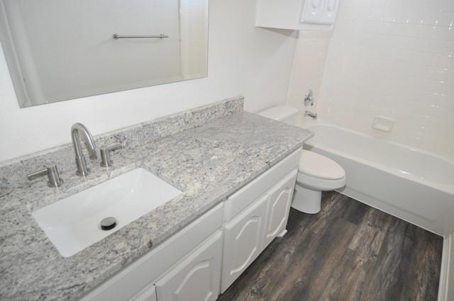 521 Mustang Ridge Drive Murphy, TX 75094 - Photo 29 of 31 a bathroom with a granite countertop sink a toilet and bathtub