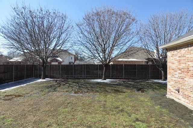 521 Mustang Ridge Drive Murphy, TX 75094 - Photo 31 of 31 a backyard of a house with lots of green space