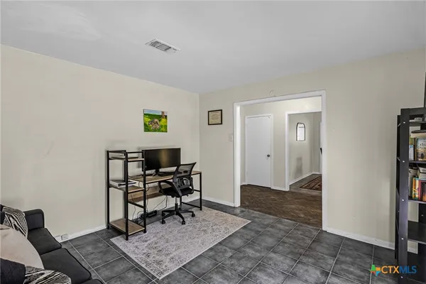 a work room with furniture and a rug