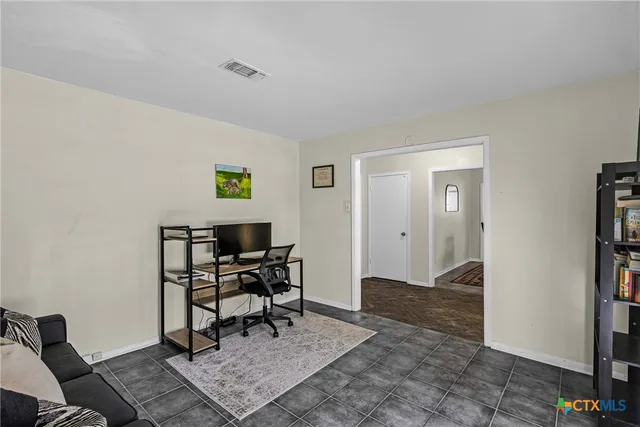 a work room with furniture and a rug