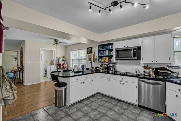 a kitchen with sink cabinets and appliances