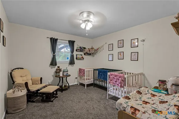 a bedroom with furniture and a chandelier
