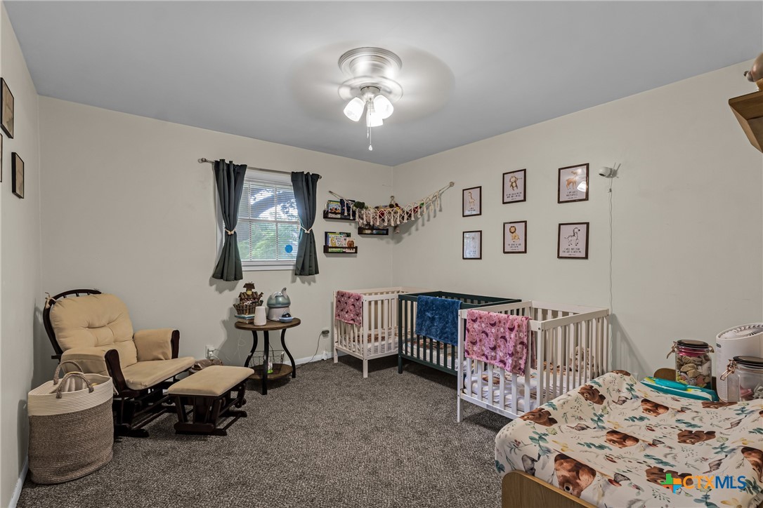 1604 North Cleveland Avenue Cameron, TX 76520 - Photo 28 of 46 a bedroom with furniture and a chandelier