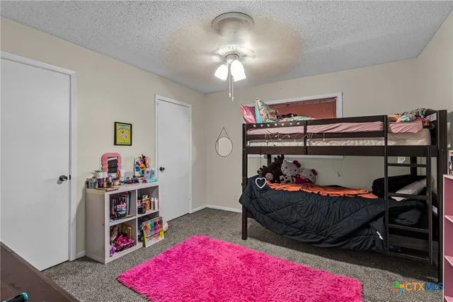 a bedroom with bed and a book shelf