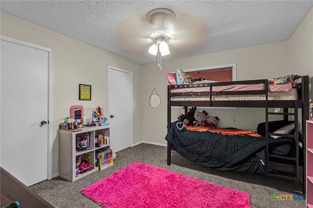 1604 North Cleveland Avenue Cameron, TX 76520 - Photo 32 of 46 a bedroom with bed and a book shelf