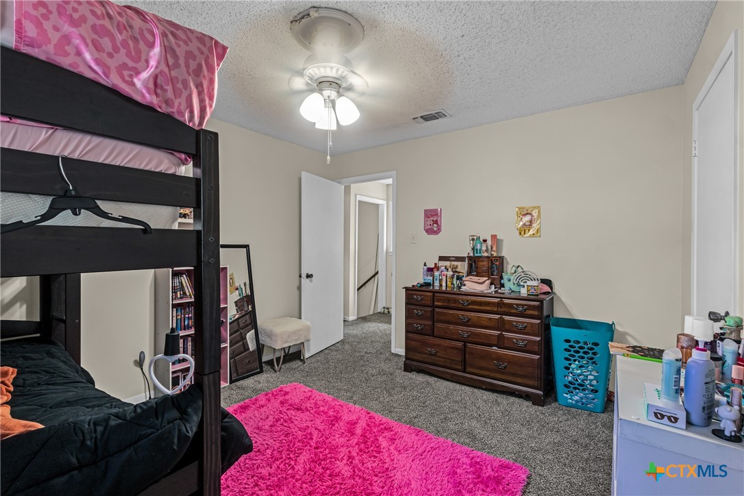 1604 North Cleveland Avenue Cameron, TX 76520 - Photo 33 of 46 a bed room with a bed and a chandelier