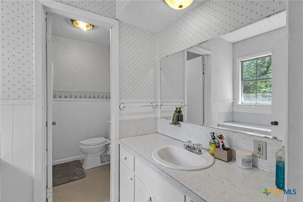 a bathroom with a sink toilet and tub