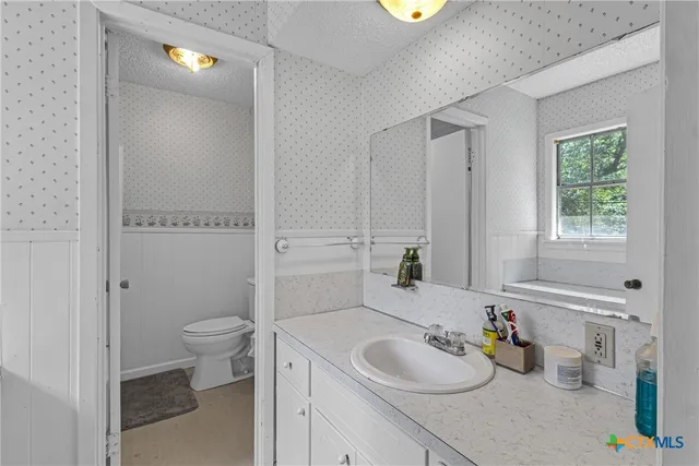 a bathroom with a sink toilet and tub