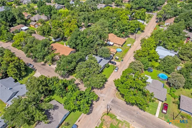 an aerial view of a house with a yard basket ball court and outdoor seating