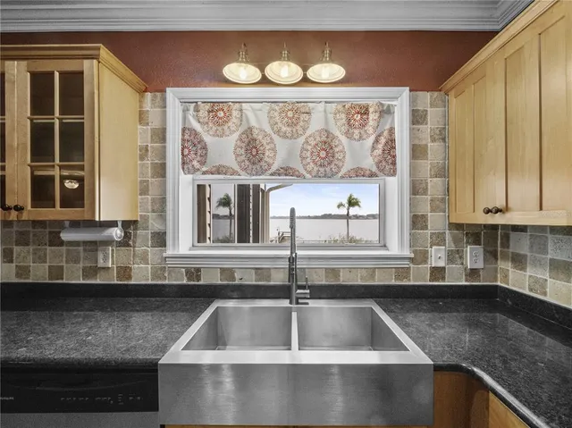 a kitchen with granite countertop a sink and a stove