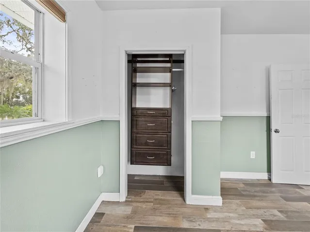 a view of walk in closet with empty racks
