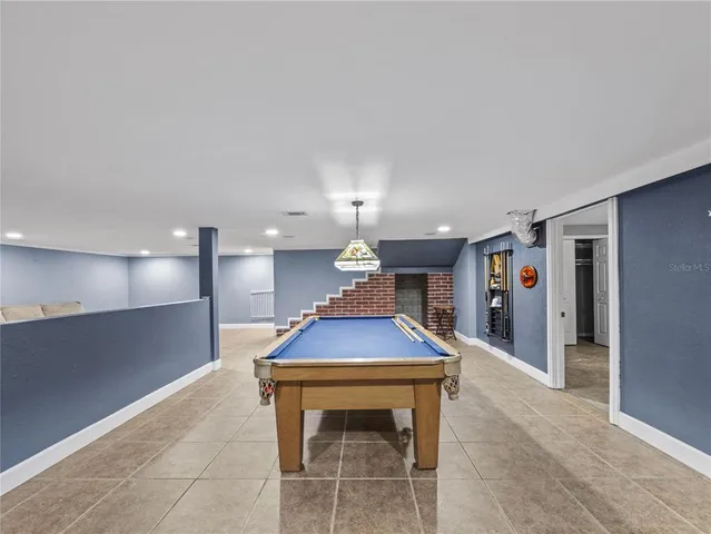 a room with pool table table and chairs