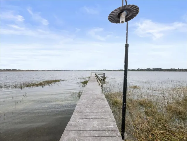 a view of a swimming pool with a yard