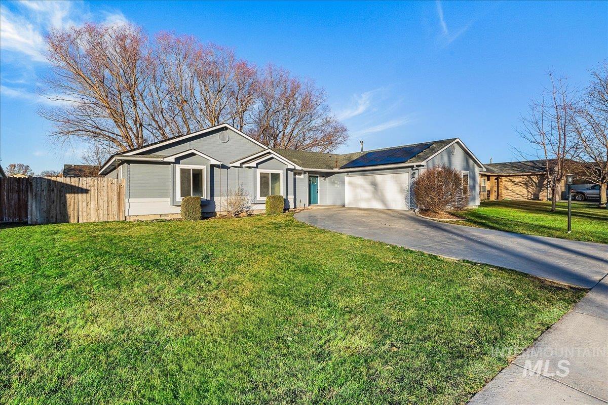 411 Hawthorne Street Nampa, ID 83686 - Photo 1 of 48 Ranch-style home featuring concrete driveway, roof mounted solar panels, and a garage