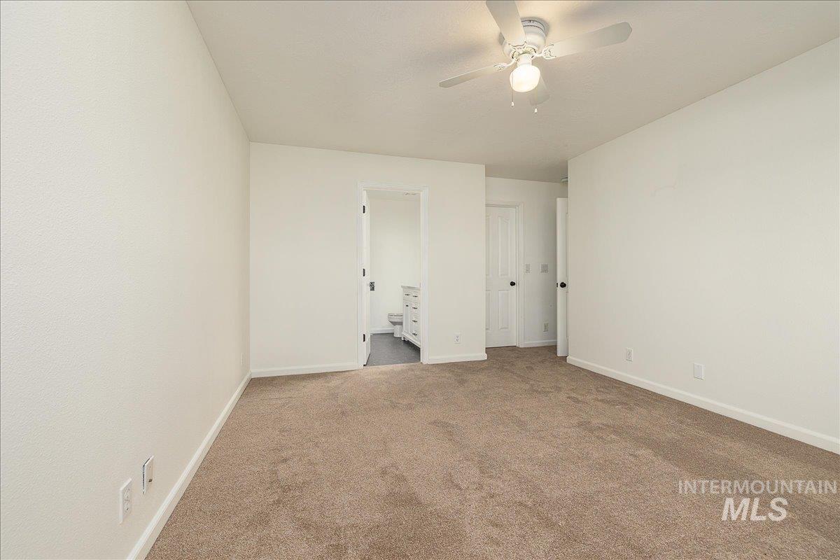 411 Hawthorne Street Nampa, ID 83686 - Photo 16 of 48 Unfurnished bedroom with carpet floors, ensuite bath, and ceiling fan