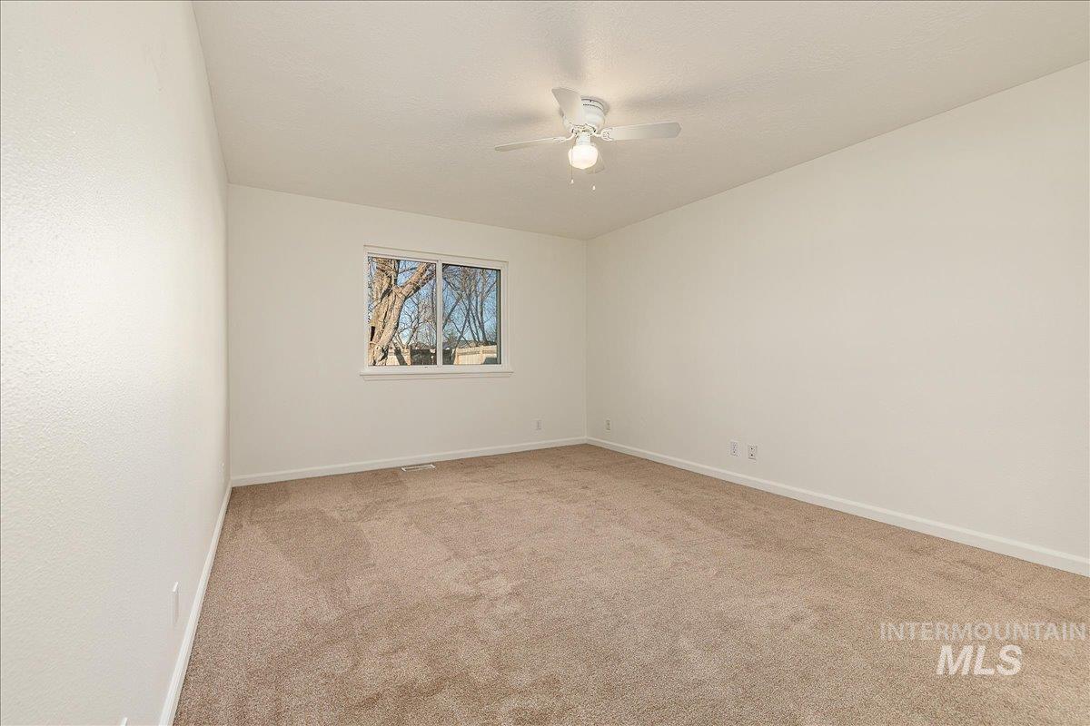 411 Hawthorne Street Nampa, ID 83686 - Photo 20 of 48 Empty room featuring light colored carpet and ceiling fan