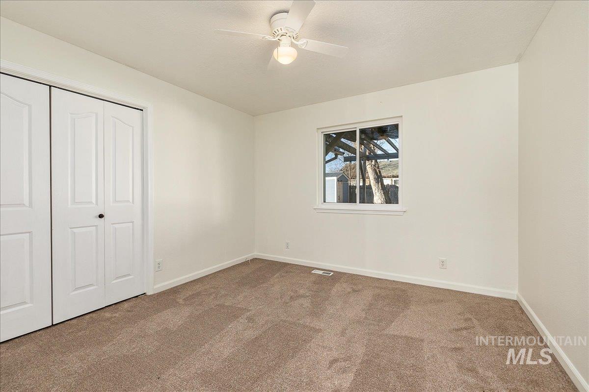 411 Hawthorne Street Nampa, ID 83686 - Photo 29 of 48 Unfurnished bedroom featuring a closet, carpet floors, and a ceiling fan