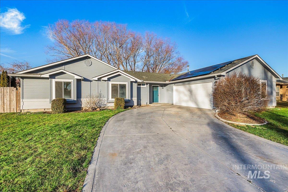411 Hawthorne Street Nampa, ID 83686 - Photo 3 of 48 Single story home with an attached garage, concrete driveway, and roof mounted solar panels