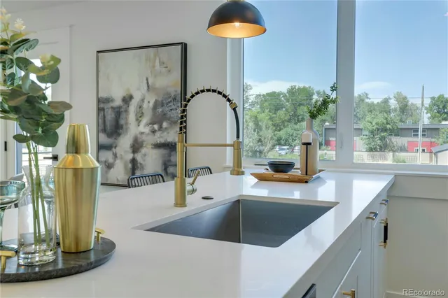 a kitchen with a sink and a mirror