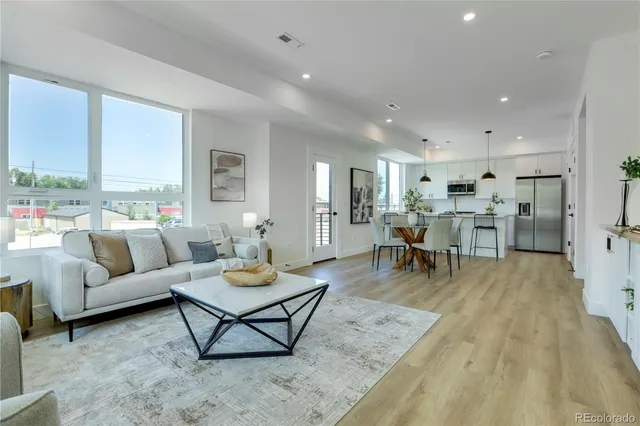 a living room with furniture and kitchen view