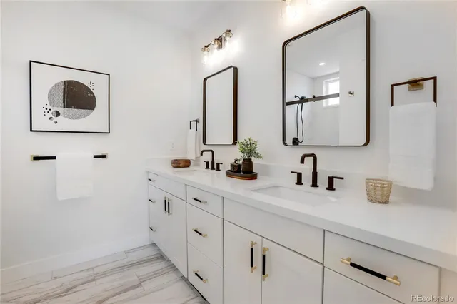a bathroom with a double vanity sink and mirror